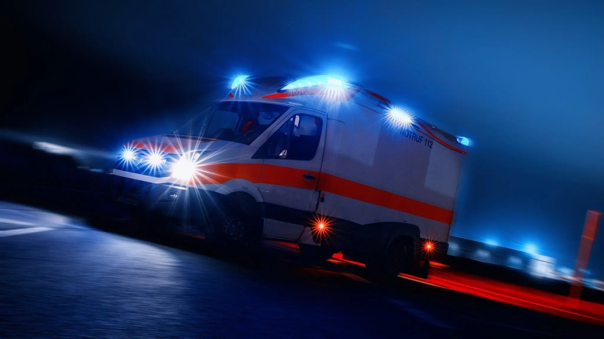An ambulance rushing to the hospital in the evening